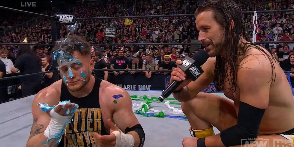 Adam Cole consoles a cake-splattered MJF