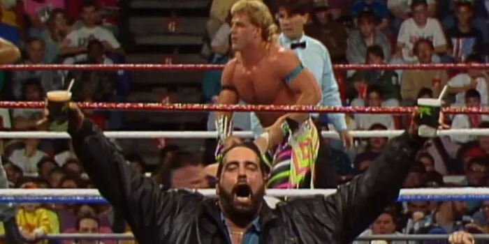 A fan decides to invade the shot, two beers in hand.