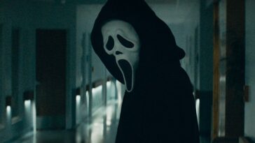 Ghostface looks down a hallway in Scream 5