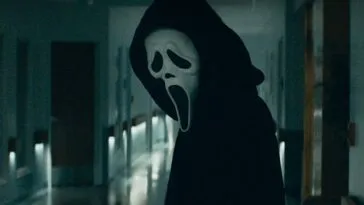 Ghostface looks down a hallway in Scream 5