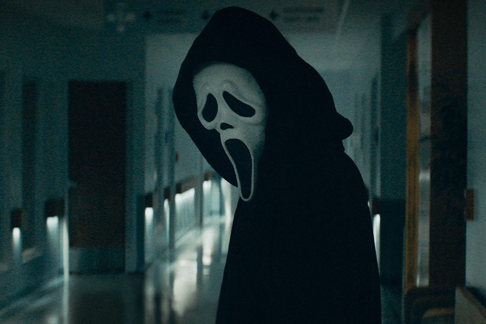 Ghostface looks down a hallway in Scream 5