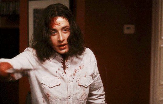 Charlie covered in blood looks ahead in Scream 4