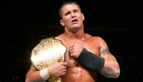 An emotional Randy Orton holds the Big Gold Belt after just winning it.