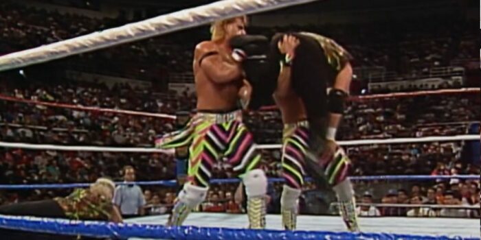 Marty Jannetty lifts Sags, whose feet smash into Michaels's face.