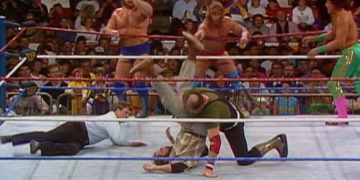 Sgt Slaughter performs a high-angle school boy on Skinner as his teammates cheer him on.