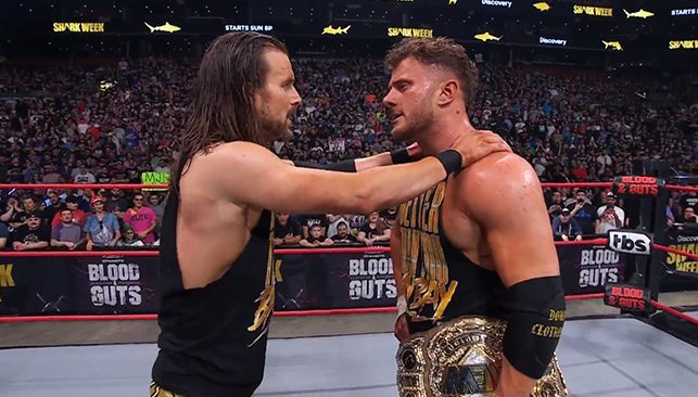 Adam Cole encouraging his Better Than You Baybay team mate MJF in the ring