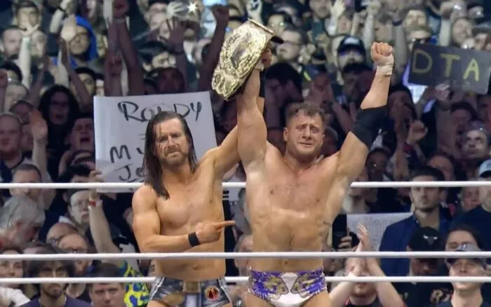 Adam Cole celebrating his Better Than You Baybay partner MJF's victory at All In