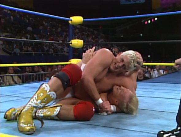 Dustin Rhodes holds Stunning Steve Austin in a headlock