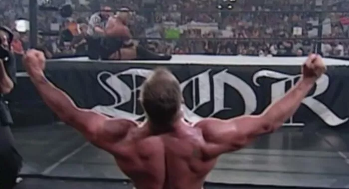 Kurt Angles celebrates outside of the ring on his knees after winning the tournament in 2000.