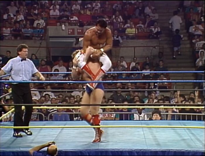 Ricky Steamboat has Steven Regal in an armbar, even as Regal has him up in the air!