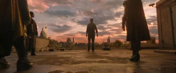 Mr. Geckle walks toward the edge of a building as three people stand behind him, watching in horror.