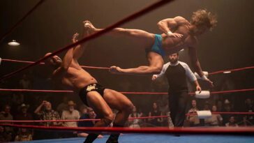 Zac Efron as Kevin Von Erich drop kicks an opponent in The Iron Claw (2023)