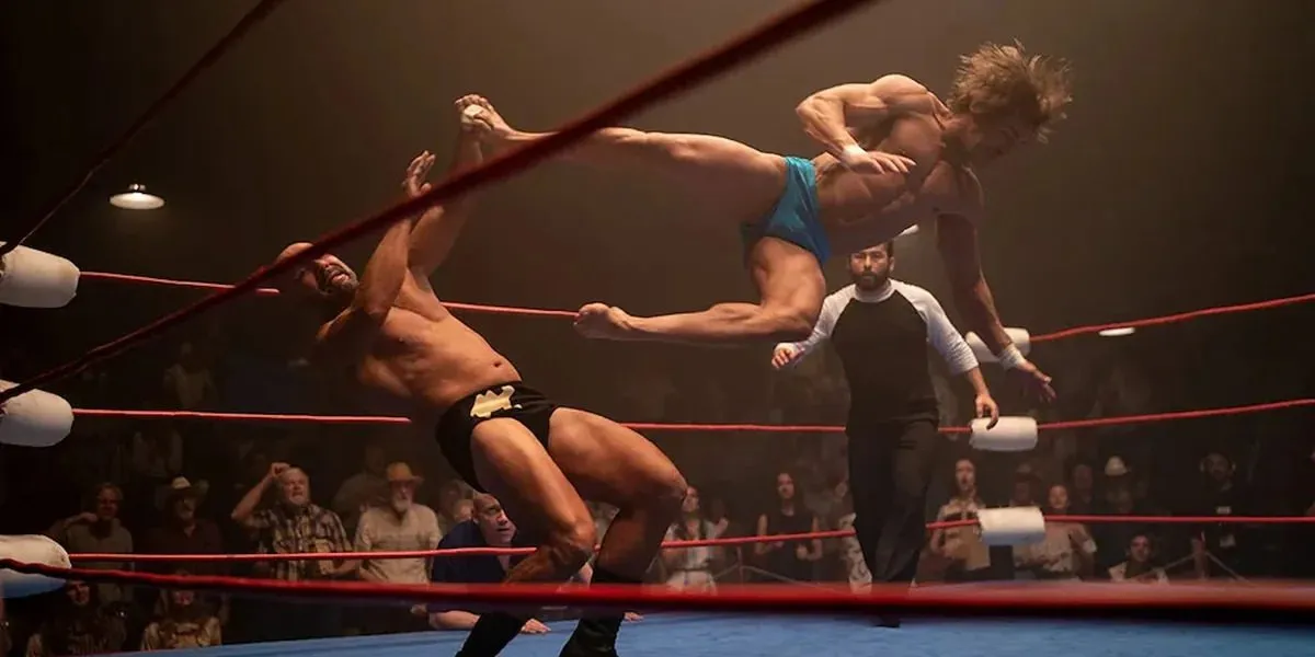 Zac Efron as Kevin Von Erich drop kicks an opponent in The Iron Claw (2023)