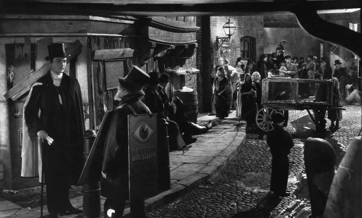 A group of people walk cobblestone streets