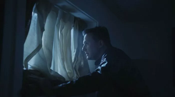 A man looking out a window
