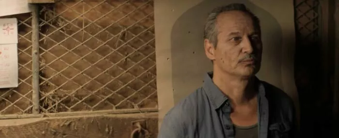 A man standing by a wall