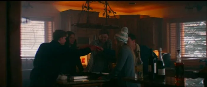 A group of adults raise small, red plastic cups to toast the new year in Snow Falls.