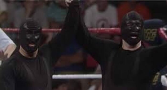 The Executioners, in all black gear, pose prior to a match.