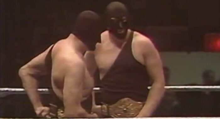 The Executioners, donning the tag belts, in the ring, wearing all-black.