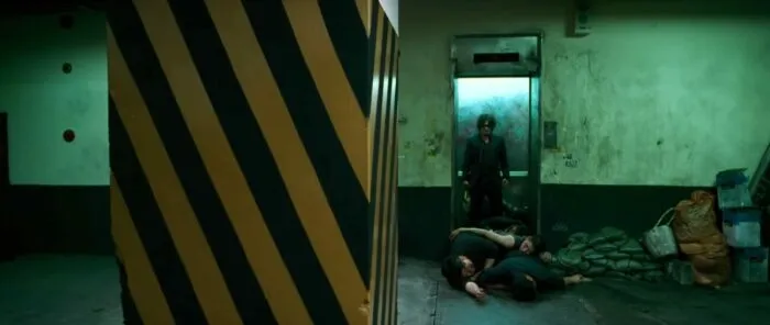 Dae-su coming out of an elevator with passed out enemies