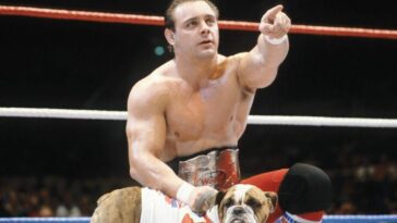Dynamite Kid, with Matilda the dog, points at his opponent.