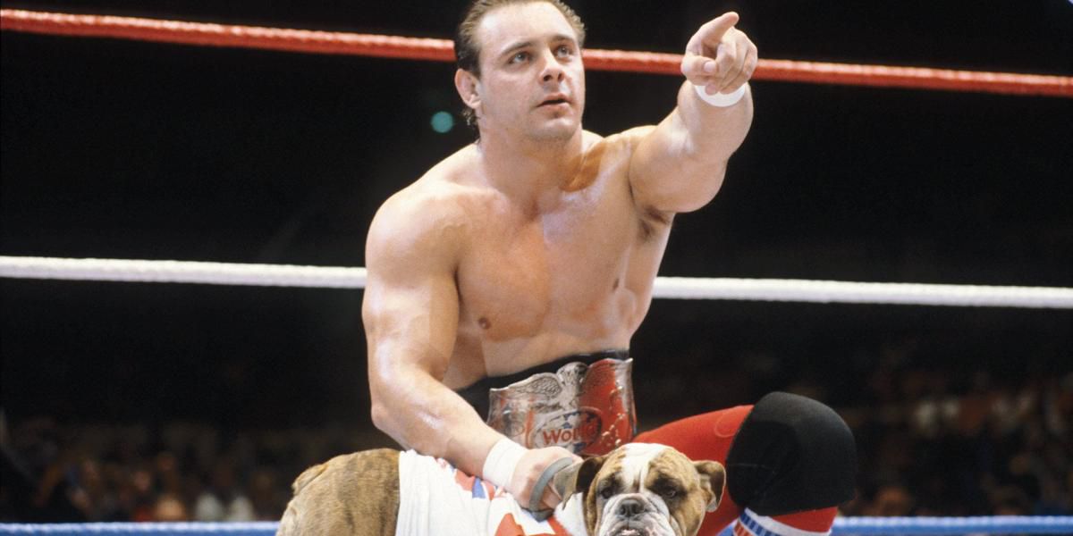 Dynamite Kid, with Matilda the dog, points at his opponent.
