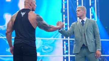 The Rock and Cody Rhodes clutch hands during this past Friday's Smackdown.