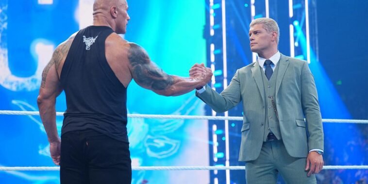 The Rock and Cody Rhodes clutch hands during this past Friday's Smackdown.