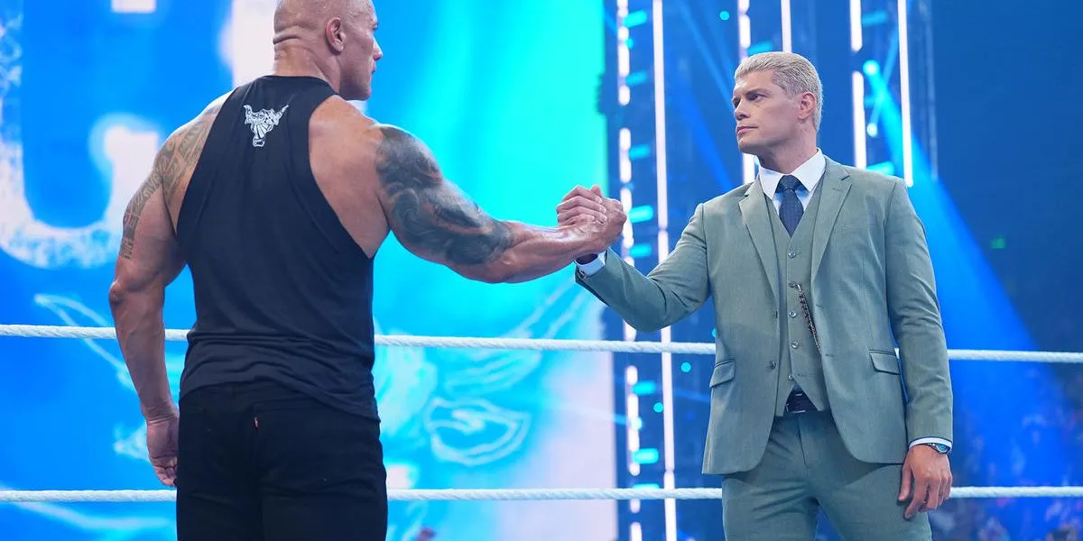 The Rock and Cody Rhodes clutch hands during this past Friday's Smackdown.