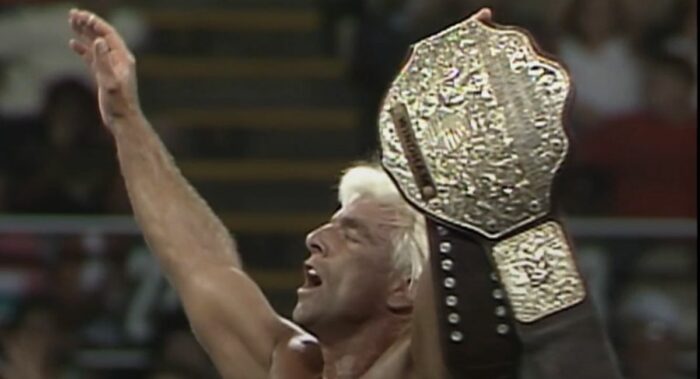 Ric Flair holds aloft the Big Gold Belt.