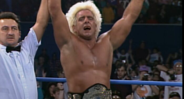 An emotional Ric Flair has his hand raised by ref Randy Anderson at Starrcade '93