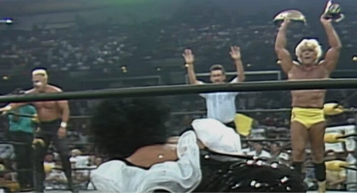 Ric Flair holds aloft the WCW International Championship belt as Sensational Sherri rolls into the ring