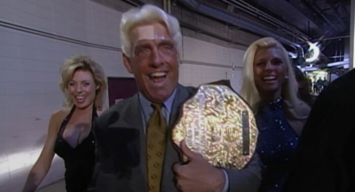 Ric Flair and the ladies stroll backstage as Flair brandishes the Big Gold Belt