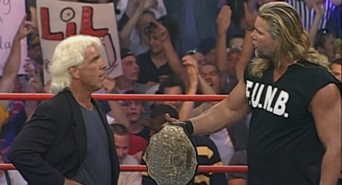 Kevin Nash hands over the Big Gold Belt to Ric Flair