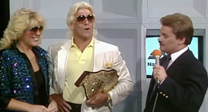 Tony Schivone admires the Big Gold Belt as Ric Flair and Baby Doll.