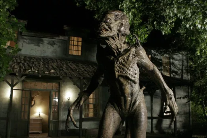A monstrous alien stands in front of the McCoy's house, looking for his next victim