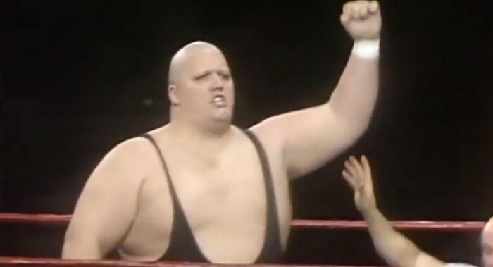 King Kong Bundy raises his hand up in victory