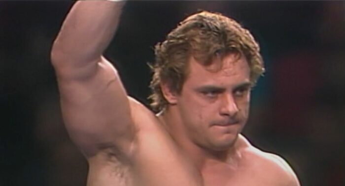 Dynamite Kid raises his hand while deep in thought - dreaming of the WWE Hall of Fame?