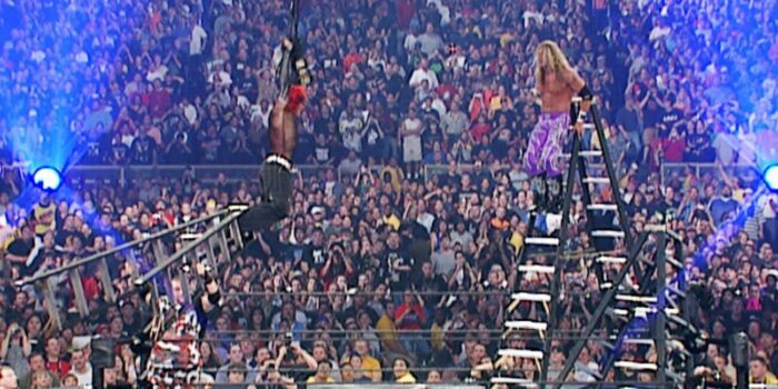 Edge prepares to leap from a ladder at a dangling Jeff Hardy during TLC II at WrestleMania X7