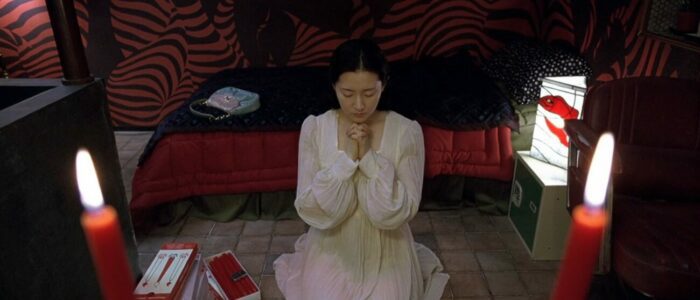 A woman kneeling in prayer