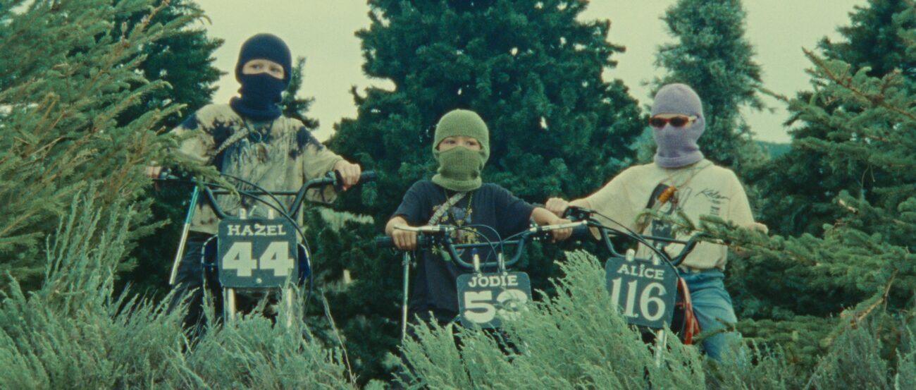 Three masked kids on bikes