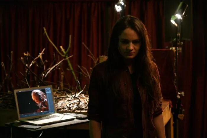 A woman in front of a stop-motion filming set