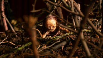 A stop-motion doll surrounded by twigs