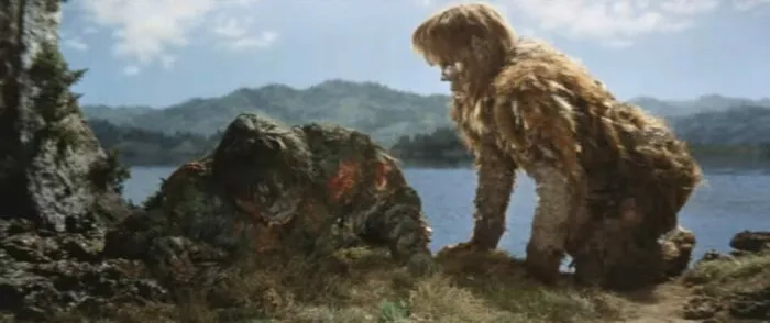 A giant monster kneeling by his wounded brother