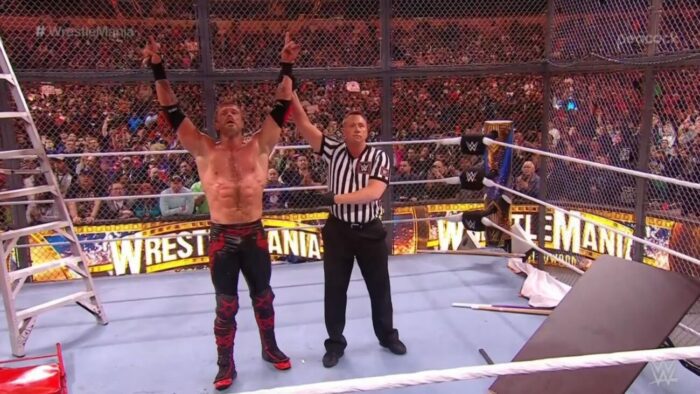 Edge has his arm raised in the plunder-filled Hell in a Cell at WrestleMania 39