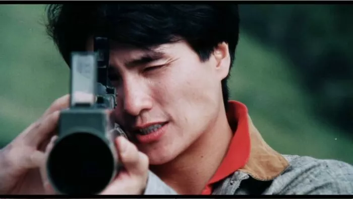 A man squints his left eye as he looks through the scope of a rocket launcher in FATAL TERMINATION