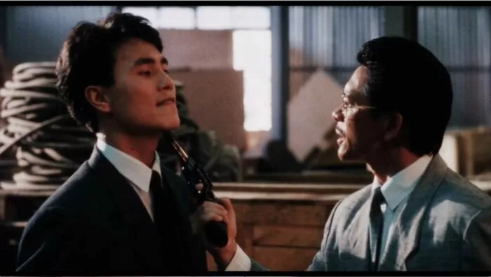 A man holds a gun under the chin of another man in Fatal Termination