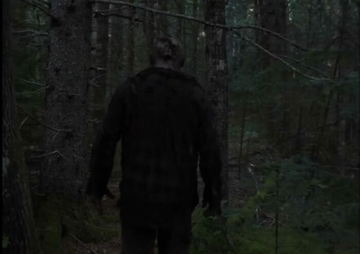A man with a flesh wound on the back of his head skulks through the woods in IN A VIOLENT NATURE
