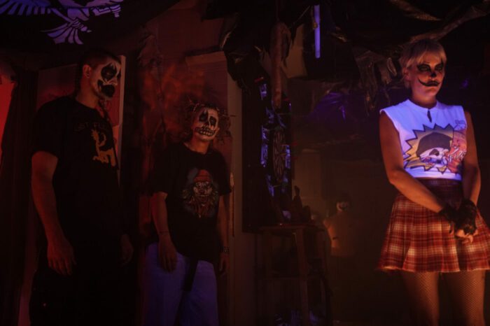 Trey, Silas, and Eden are seen in clown makeup 3 feet apart from one another.