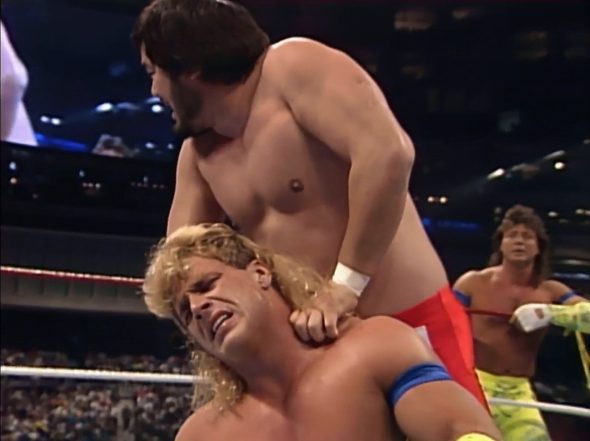 Sato has Shawn Michaels in a nerve hold as Marty Jannetty looks on.